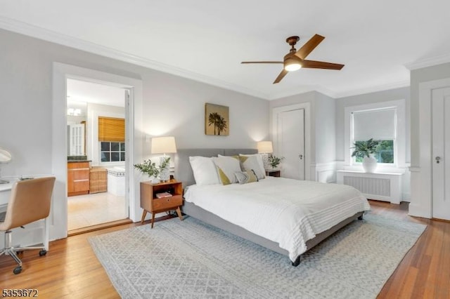 bedroom featuring radiator heating unit, crown molding, light wood-style flooring, and ceiling fan