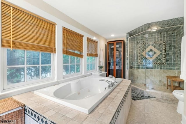 full bathroom with a shower stall, a tub with jets, tile patterned floors, toilet, and recessed lighting