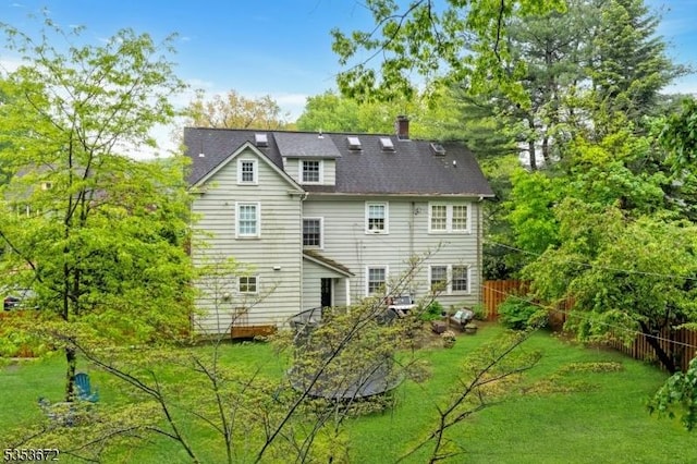 back of house featuring a chimney