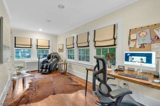 office area with ornamental molding, wood finished floors, radiator, baseboards, and recessed lighting