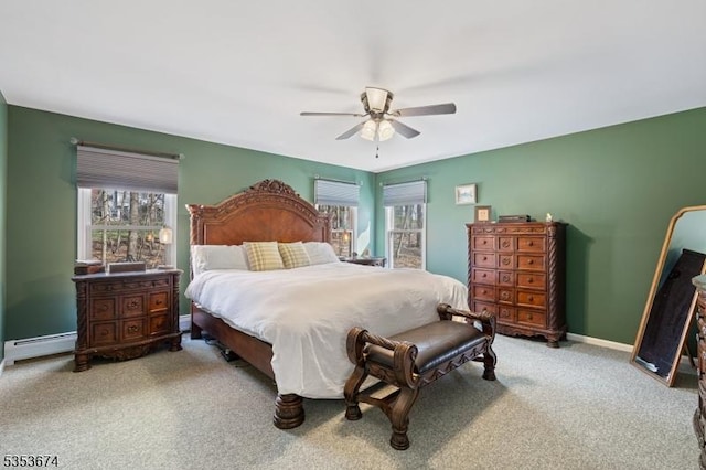 bedroom featuring light colored carpet, baseboards, ceiling fan, and multiple windows