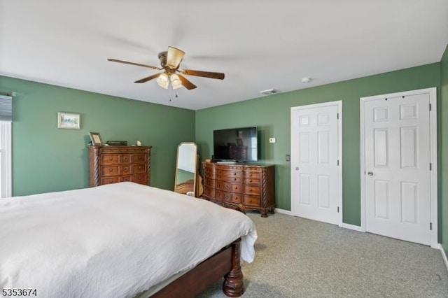 bedroom featuring carpet floors, a ceiling fan, baseboards, and visible vents