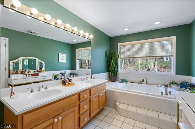full bathroom featuring tile patterned floors, visible vents, a sink, and a bath