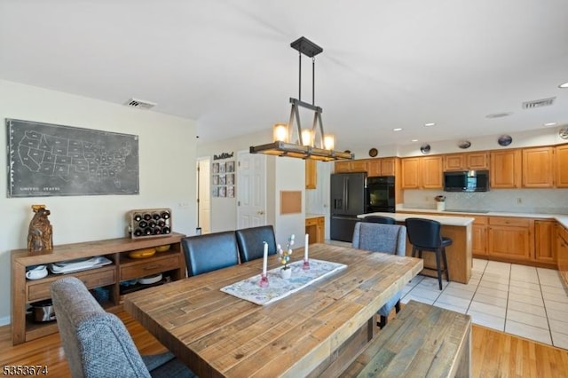 dining room featuring recessed lighting, light wood finished floors, and visible vents