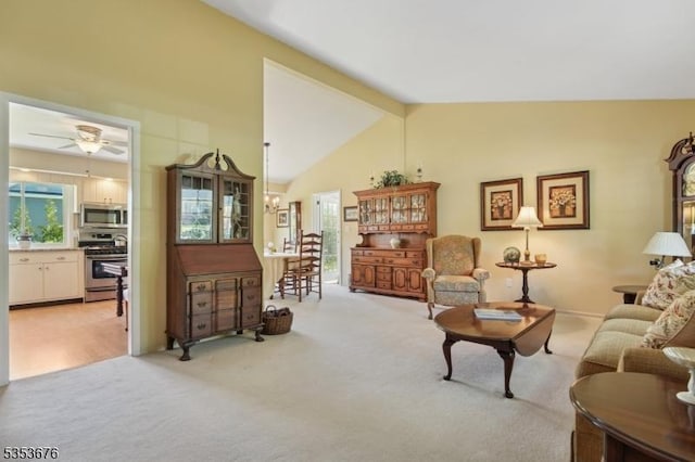 living room featuring high vaulted ceiling, ceiling fan, light carpet, and beamed ceiling