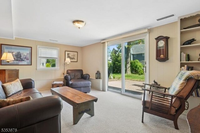 carpeted living area featuring visible vents