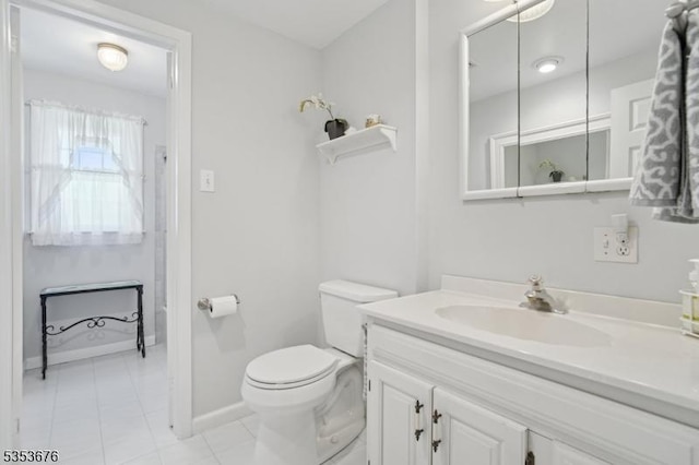 bathroom featuring baseboards, tile patterned flooring, toilet, and vanity