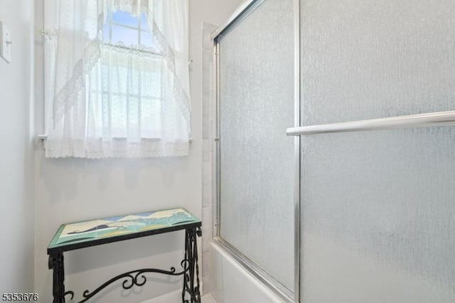 full bathroom with shower / bath combination with glass door