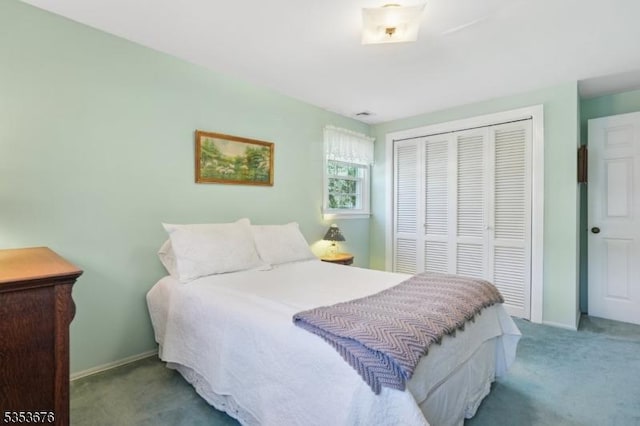 bedroom with a closet, carpet flooring, and baseboards