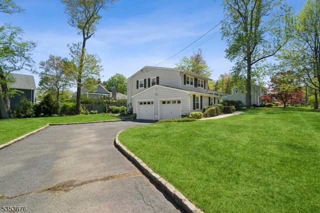 view of property exterior featuring a lawn, driveway, and a garage