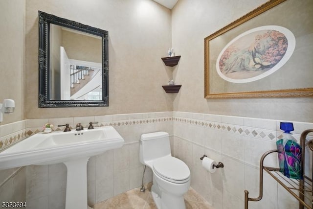 bathroom featuring wainscoting and toilet