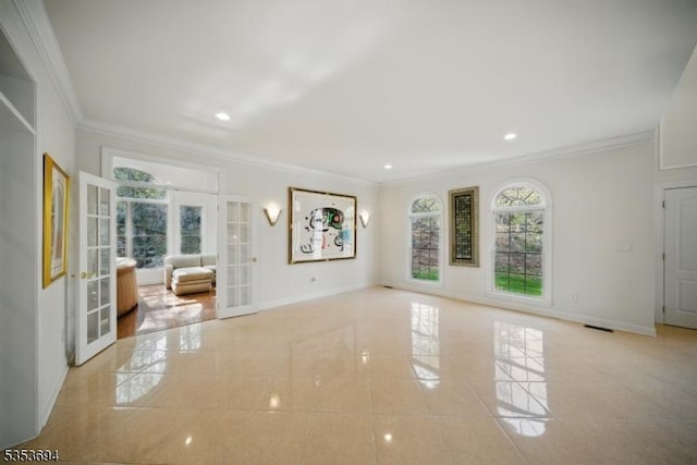unfurnished living room with crown molding, french doors, and a healthy amount of sunlight