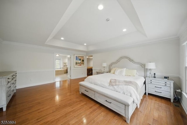 bedroom with light wood-style floors, recessed lighting, a raised ceiling, and crown molding