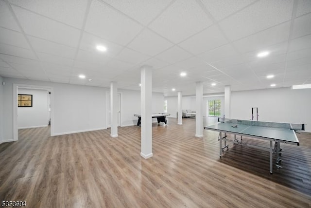 playroom with recessed lighting, baseboards, a drop ceiling, and wood finished floors