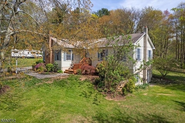 back of house with a lawn and a chimney