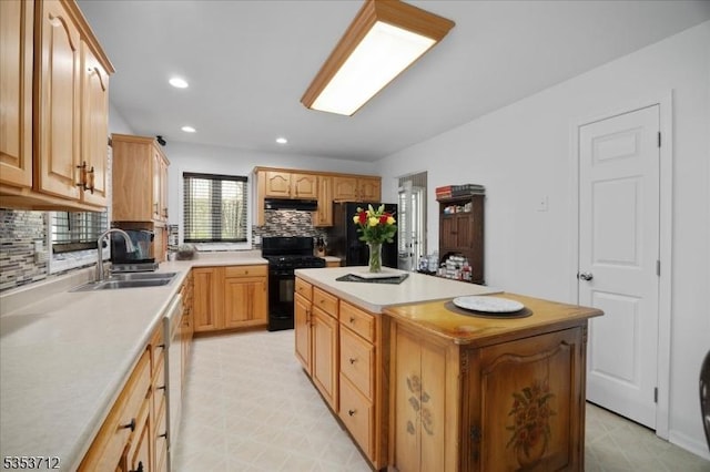 kitchen with black appliances, a sink, under cabinet range hood, a center island, and backsplash