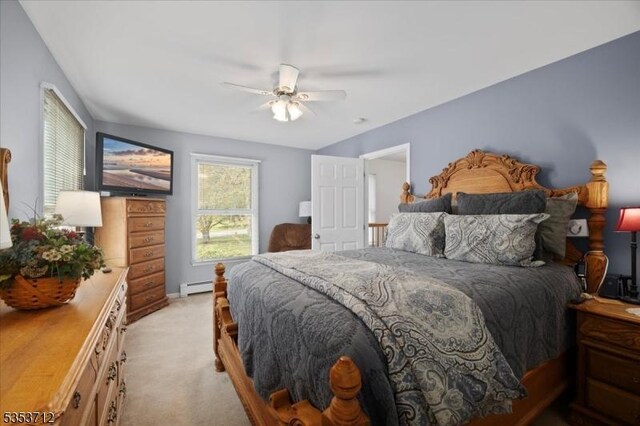 bedroom with baseboard heating, light carpet, and ceiling fan