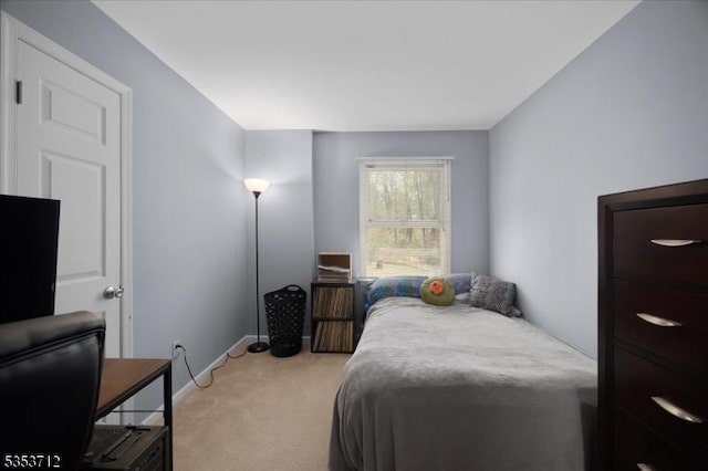 bedroom with light carpet and baseboards