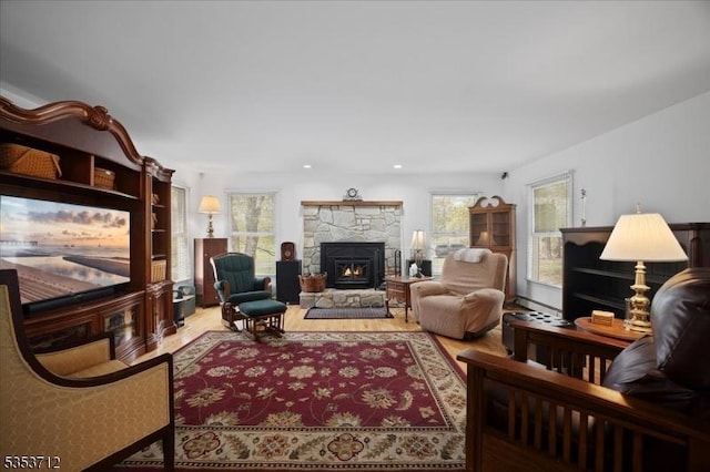living area with a fireplace, wood finished floors, and recessed lighting