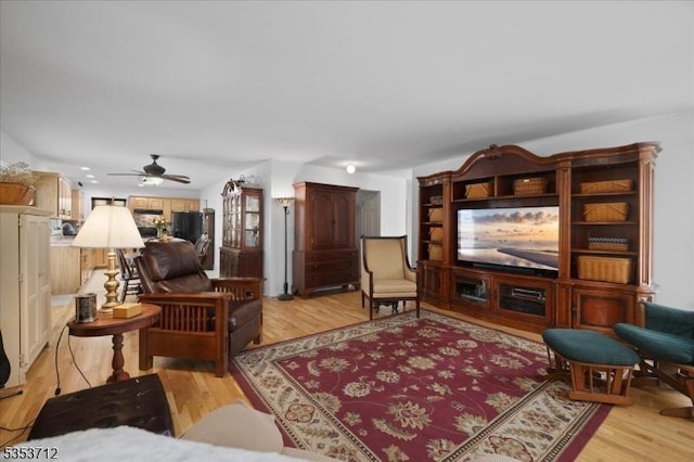 living room featuring light wood-type flooring and ceiling fan