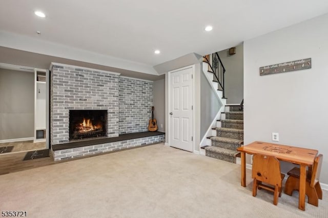 living area with recessed lighting, baseboards, stairway, a fireplace, and carpet floors