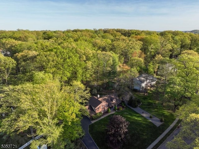 drone / aerial view featuring a wooded view