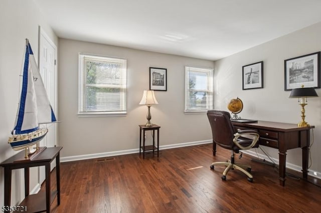 home office featuring baseboards, plenty of natural light, and wood finished floors