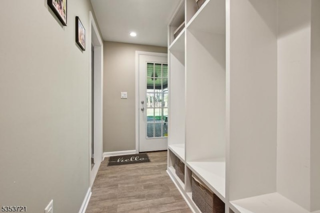 mudroom with light wood finished floors, baseboards, and recessed lighting