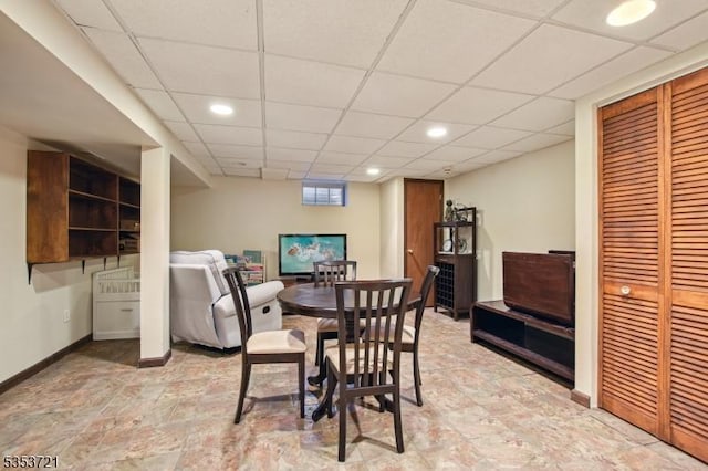dining room with a drop ceiling, baseboards, and recessed lighting