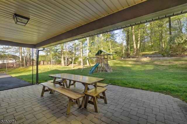 view of patio with a playground and outdoor dining space