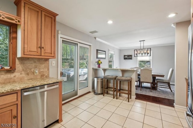 kitchen with dishwasher, plenty of natural light, visible vents, and light tile patterned flooring