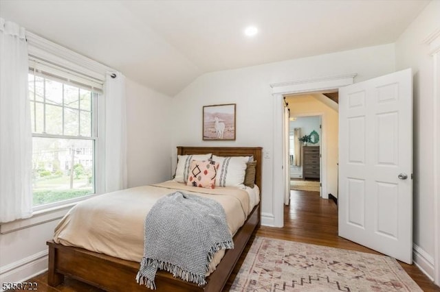 bedroom featuring lofted ceiling, wood finished floors, baseboards, and recessed lighting