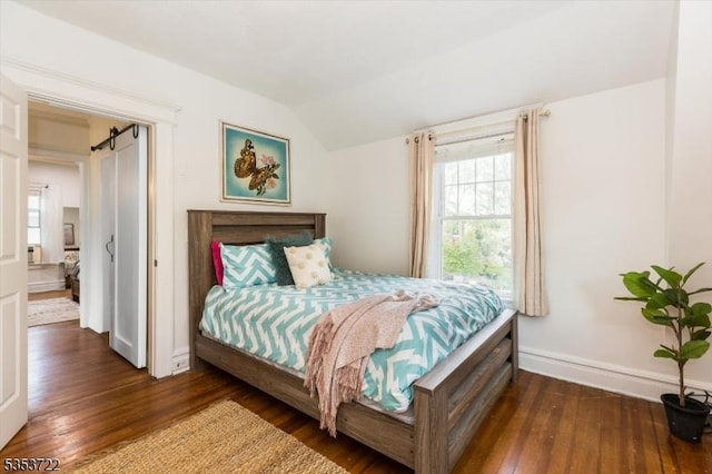 bedroom with hardwood / wood-style floors, vaulted ceiling, and baseboards