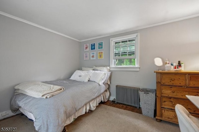 carpeted bedroom with radiator and ornamental molding