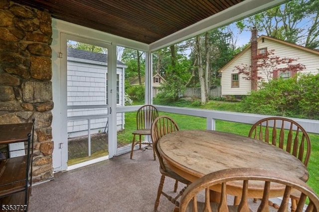 sunroom / solarium with outdoor dining space