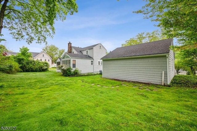 back of house with a lawn