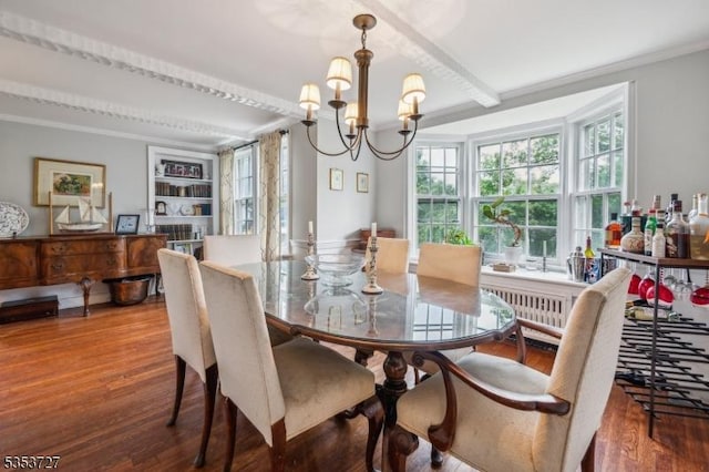 dining space featuring wood finished floors, a chandelier, radiator, and ornamental molding