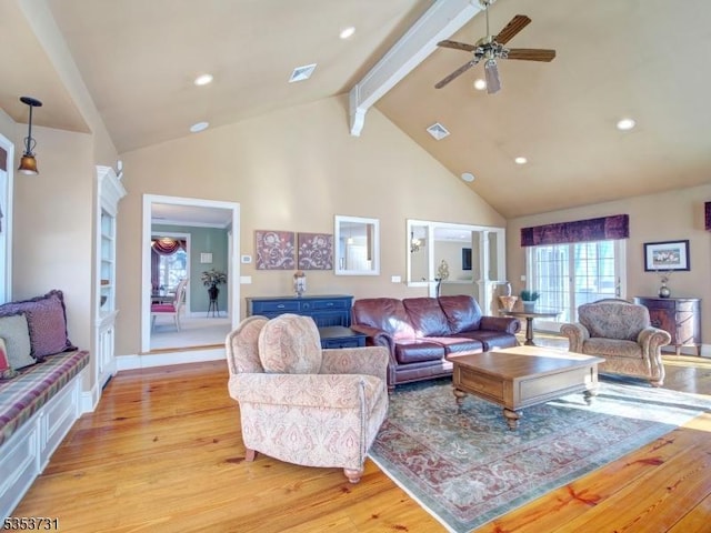 living room with visible vents, high vaulted ceiling, a ceiling fan, and light wood finished floors