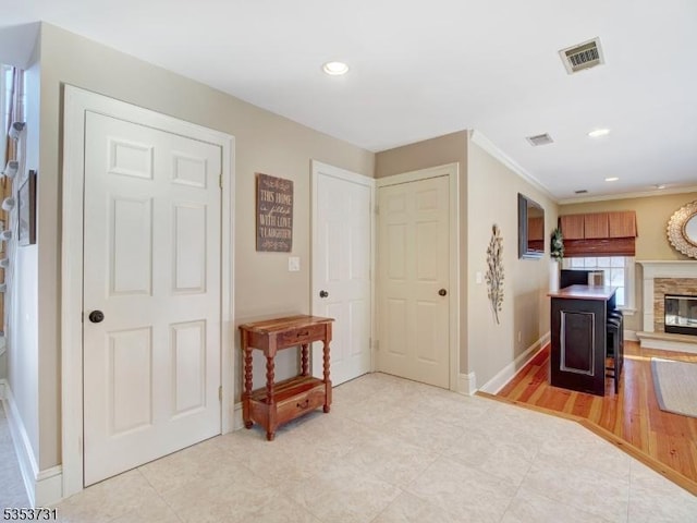interior space featuring visible vents, recessed lighting, a stone fireplace, and baseboards