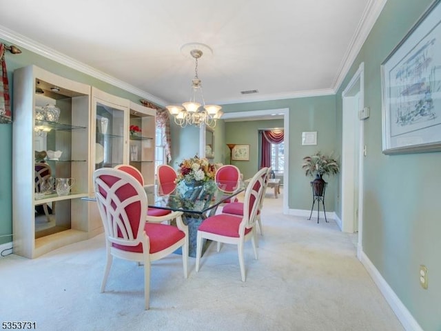 dining space with ornamental molding, visible vents, light carpet, and a chandelier