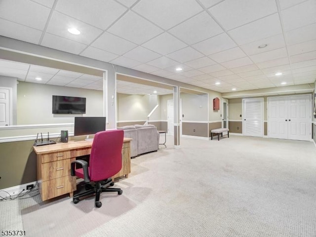 carpeted office space featuring recessed lighting, a drop ceiling, and baseboards