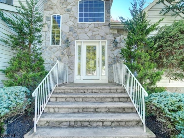 doorway to property with stone siding