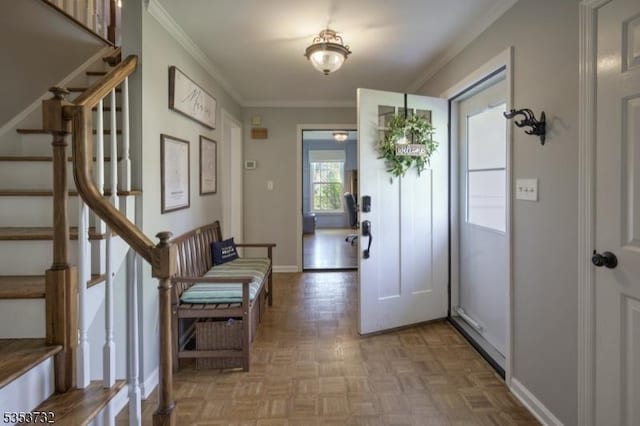 foyer featuring stairway, ornamental molding, and baseboards