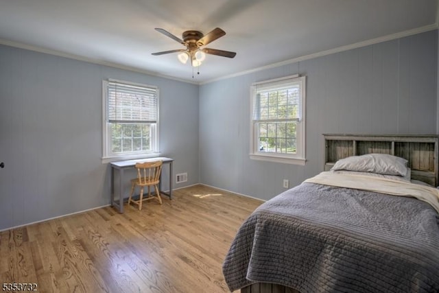 bedroom with visible vents, wood finished floors, ceiling fan, and crown molding