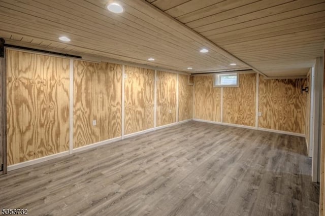 basement with wood ceiling, wood finished floors, recessed lighting, and baseboards