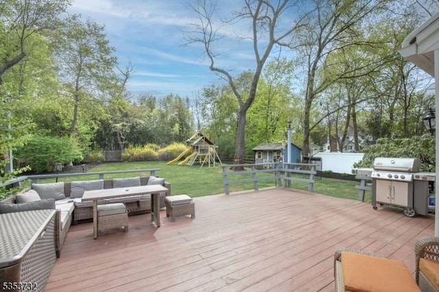 wooden terrace with an outdoor living space, a yard, a fenced backyard, a storage shed, and a playground