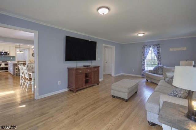 living room with baseboards, light wood-type flooring, and crown molding