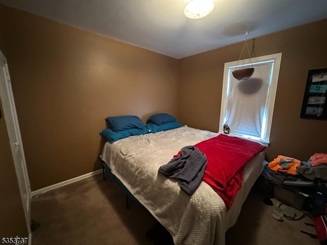 carpeted bedroom featuring baseboards