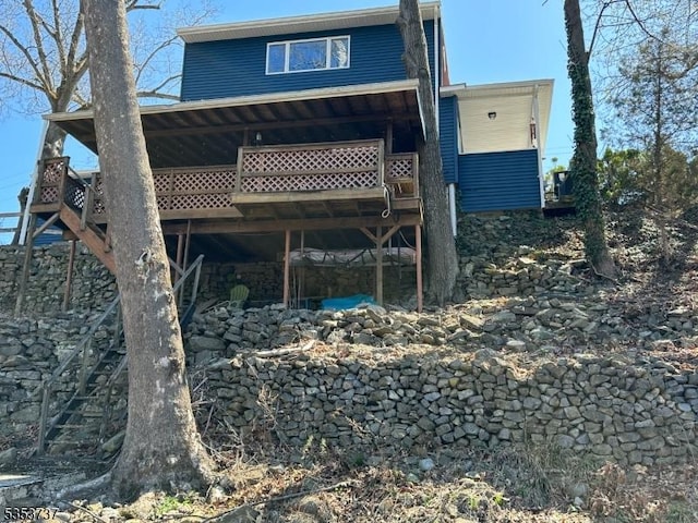 rear view of property with a wooden deck