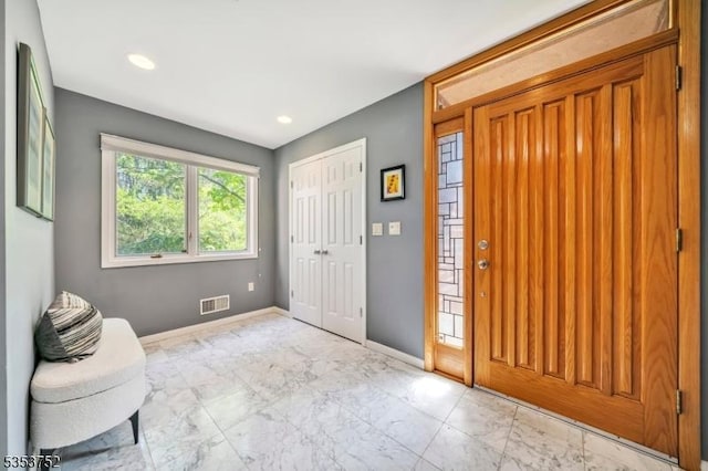 entryway featuring recessed lighting, baseboards, marble finish floor, and visible vents